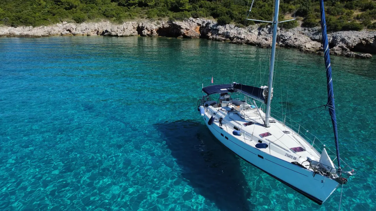 Aerial view of the Beneteau Oceanis 411 at anchor in turquoise water